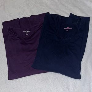 Two women within assorted shirts, one purple one navy blue ball size large